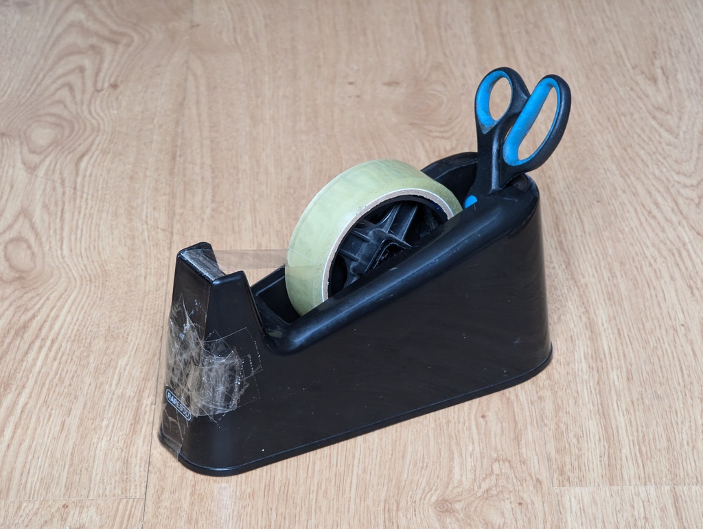 picture of a sellotape dispenser with a pair of scissors